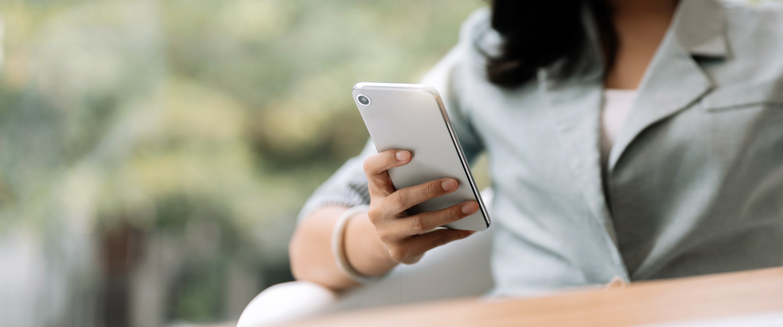 Close up business woman using smart phone, chatting social m